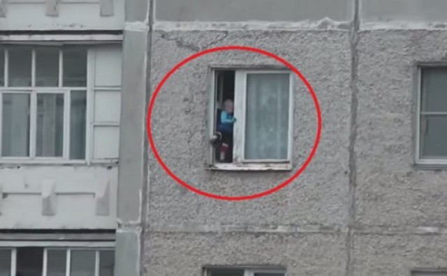 Mališan stoji na ivici prozora osmog kata, a susjedi snimaju mobitelom